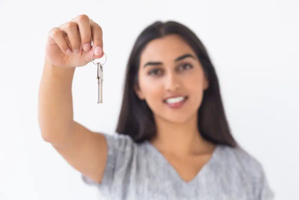 closeup smiling blurred woman raising keys
