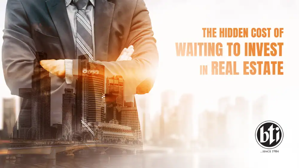 Businessman with crossed arms double-exposed with a modern cityscape, representing the urgency to invest in real estate and avoid hidden costs.